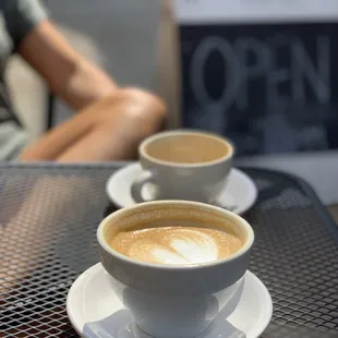 two cups of coffee on a table