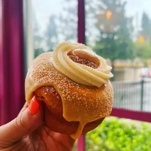 a hand holding a pastry