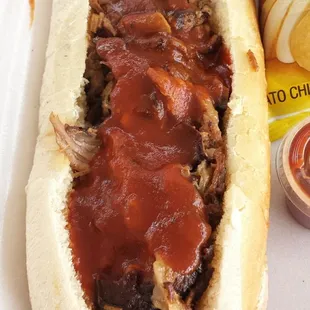 Well dressed chopped brisket sandwich.