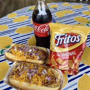 two hot dogs with cheese and onions