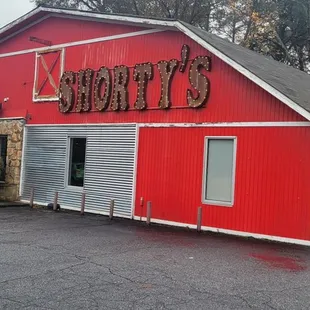 a red building with a car parked in front of it