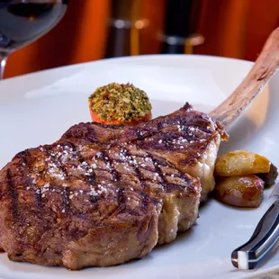 a piece of steak on a white plate