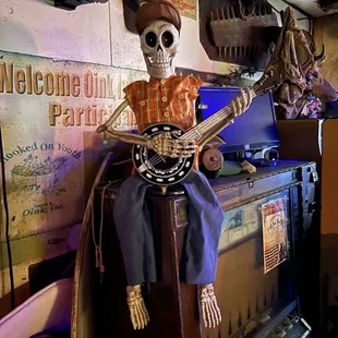 a skeleton playing a banjo