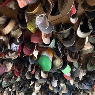a large amount of shoes hanging from the ceiling