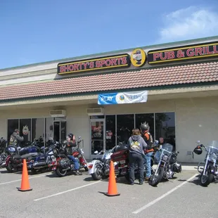 a row of motorcycles parked in front of the restaurant