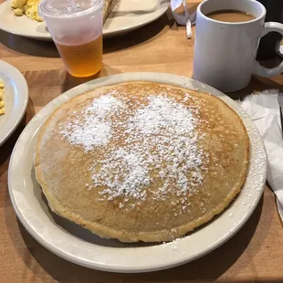 a plate of pancakes and a cup of coffee