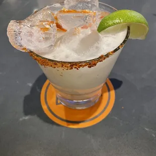 a margarita with a lime wedge