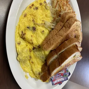 Bacon and cheese omelette, hash browns, rye toast