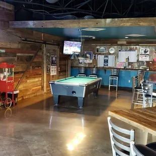 the inside of a restaurant with a pool table