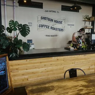 This is in a warehouse that has a mini roaster and industrial tables and giant plugs Ins for your computers.