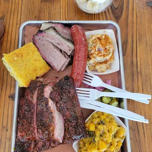 Ribs, brisket, hominy, potato salad, sausage, banana pudding