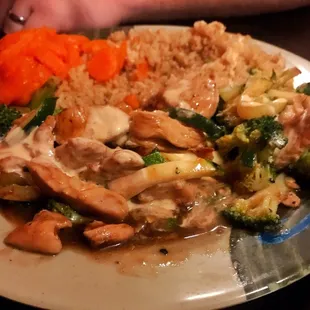 Bourbon chicken with zucchini and broccoli, fried rice with sweet carrots