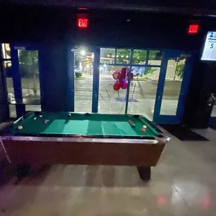 Pool table and view out the main window to broadway.