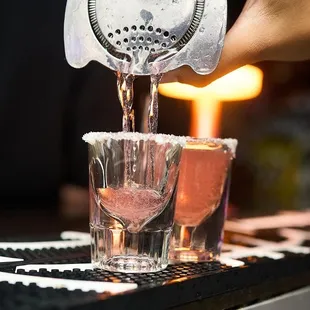 a bartender pouring a drink