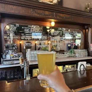 a person holding a glass of beer
