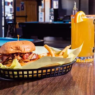 a basket of food and a glass of orange juice