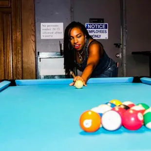 a woman playing pool