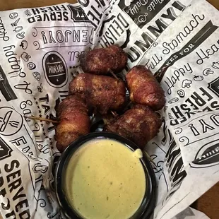 Cowboy sushi (bacon wrapped bratwurst with queso dipping sauce)