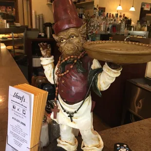 a statue of a man holding a tray