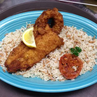 a plate of fried fish and rice