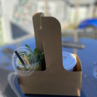 a take out container with a drink in it