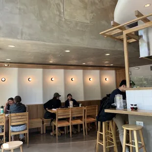 people sitting at tables in a restaurant