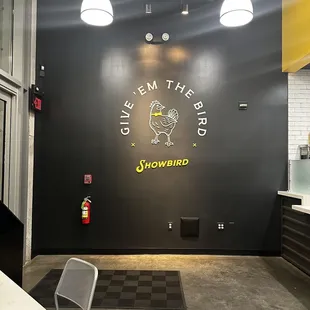 a black wall with a chicken on it
