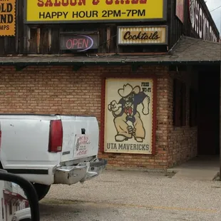 a car parked in front of a saloon