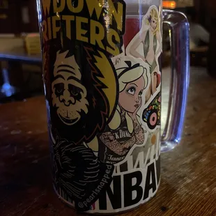 a coffee mug with stickers on it