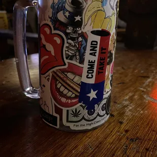 a coffee mug with stickers on it