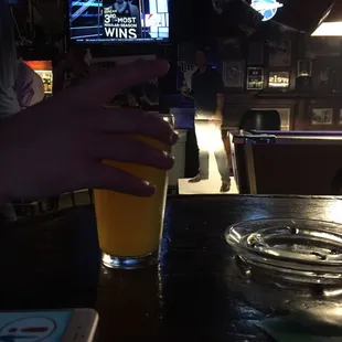 a person holding a glass of beer