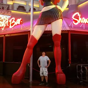 a man standing next to a statue of a woman