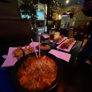 a bowl of soup with chopsticks in it