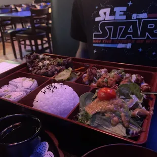 a tray of food with rice and vegetables