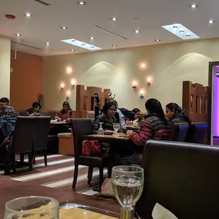 people sitting at tables in a restaurant