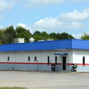 a large white building with a blue roof