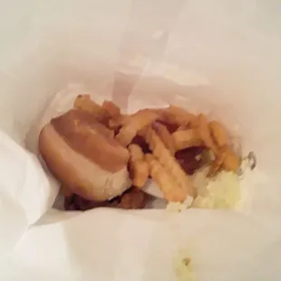 a sandwich and fries in a paper bag