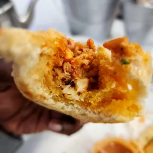 a person holding a piece of food