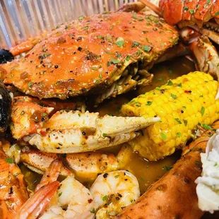 Whole dungeness, peeled shrimp, black mussels, lobster tail.