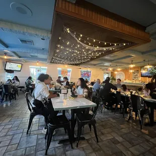 people sitting at tables in a restaurant