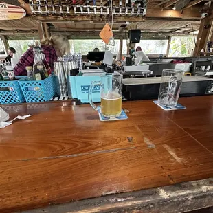 a wooden table with a beer glass on it