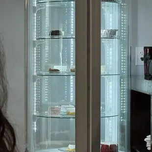 a woman looking at a display case