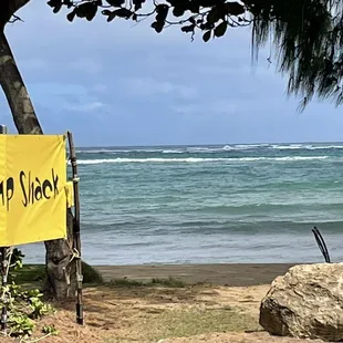 a sign on the shore of a beach