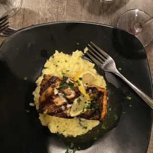 Risotto topped with grilled salmon