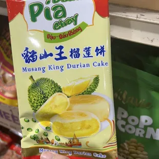 a hand holding a packet of frozen food