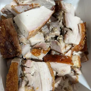 a white bowl filled with sliced meat