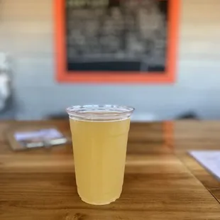 a plastic cup on a wooden table