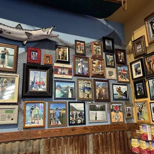 a variety of framed pictures on a wall