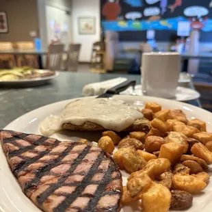 Chicken fried steak with ham and potatoes