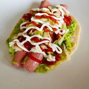 a hot dog covered in ketchup